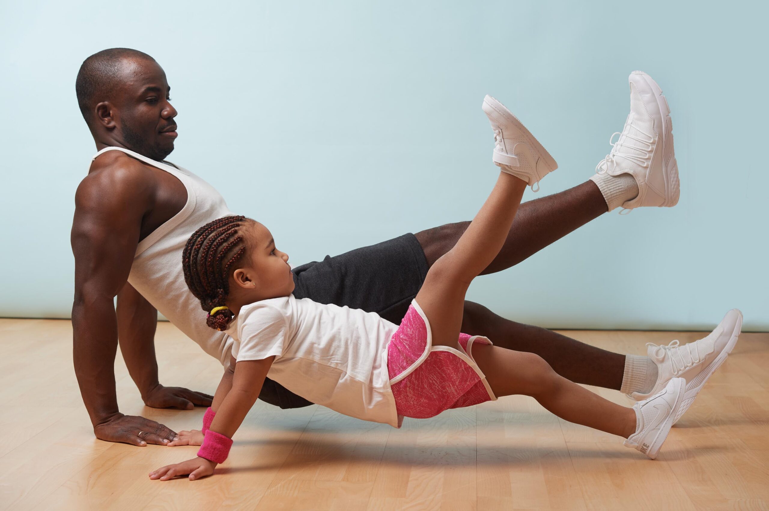 father and daughter doing yoga